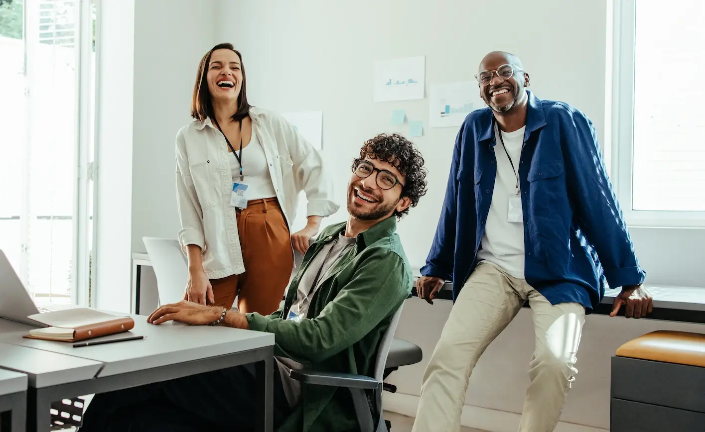 Creativ team laughing and chatting in an office environment