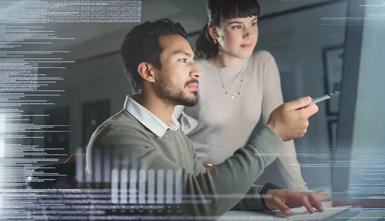 Technical engineering team standing in front of the desktop, working on security code