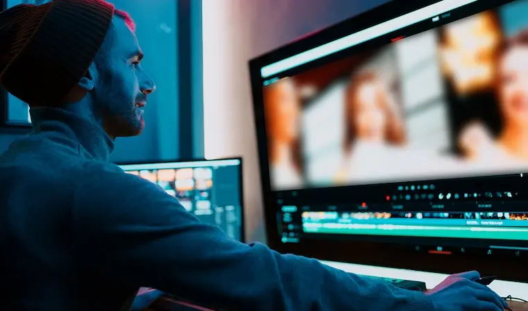 Video motion specialist creating and editing content in a program on a desktop pc