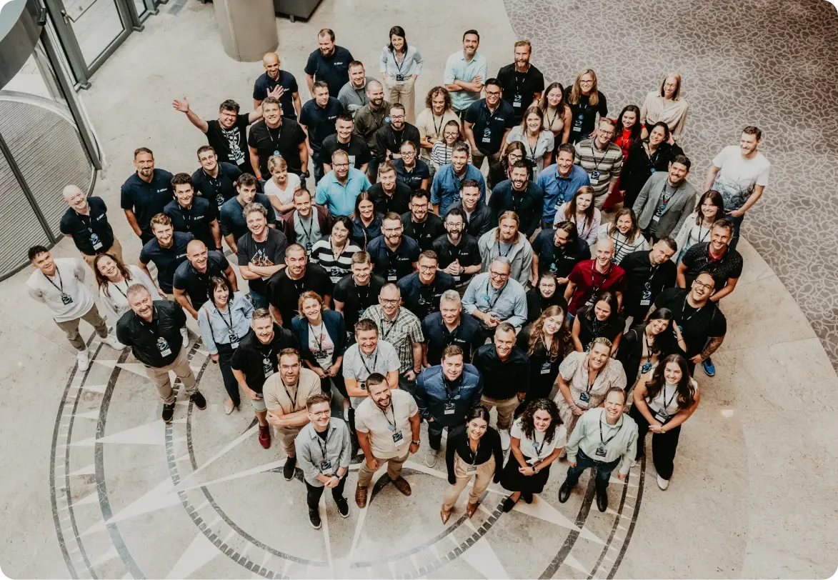 Ziflow team members standing in Warszawianka hotel main hall and smiling-2