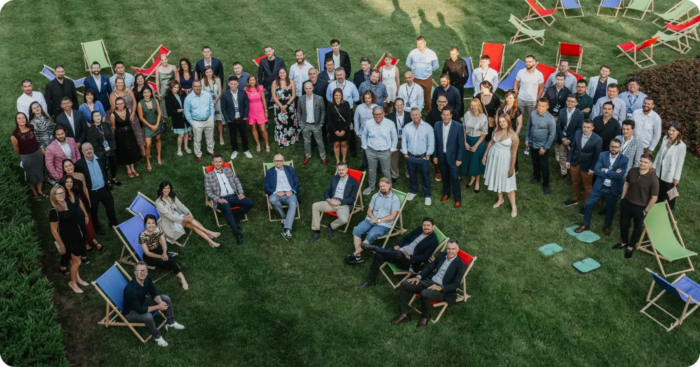 Ziflow team photo standing on the grass outside the hotel